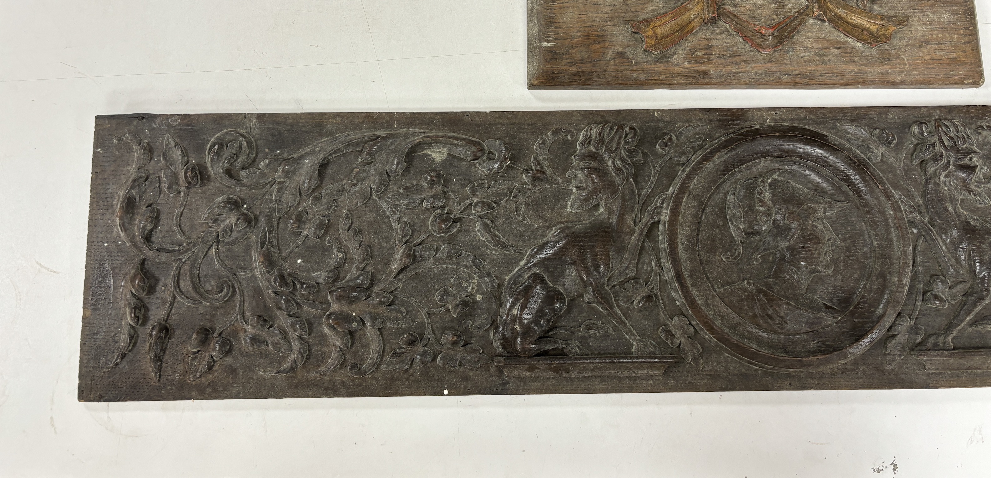 Two 18th century carved oak panels, largest 93cm wide
